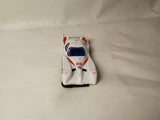 White diecast race car front view with blue and red accents, open wheels