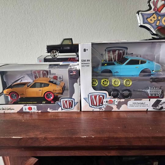 Boxed diecast car set with orange and turquoise cars, M2 branding