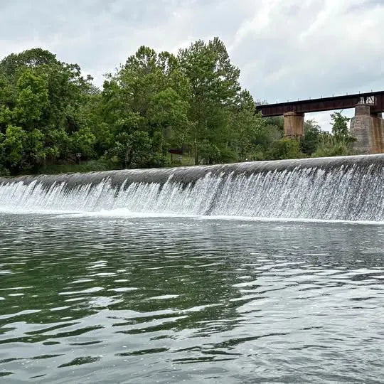 Drone footage of a river waterfall with flowing water