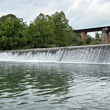 Drone footage of a river waterfall with flowing water