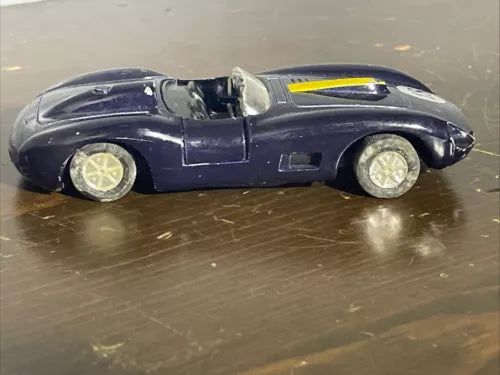 Diecast roadster convertible toy car, dark blue with yellow stripe, side view