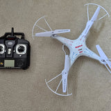White Syma quadcopter drone with four propellers, with handheld remote controller