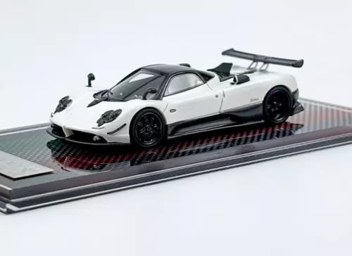 White racing sports car diecast model with black accents, on display base