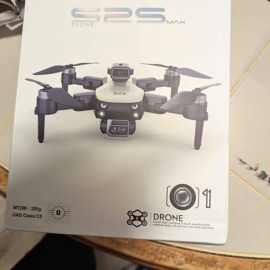 Small quadcopter drone with camera on retail box