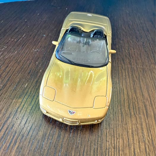 Yellow diecast sports car, 1:38 scale, front view