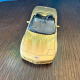 Yellow diecast sports car, 1:38 scale, front view