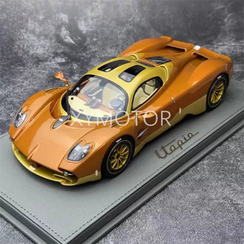 Copper diecast model car with blue accents, on display base