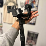 Black handheld 3-axis drone gimbal stabilizer with control handle