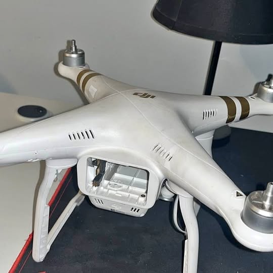 White DJI Phantom 3 drone body with front camera gimbal, parts view