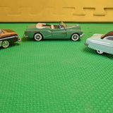 1/43 scale green diecast convertible car with tan top and wheels