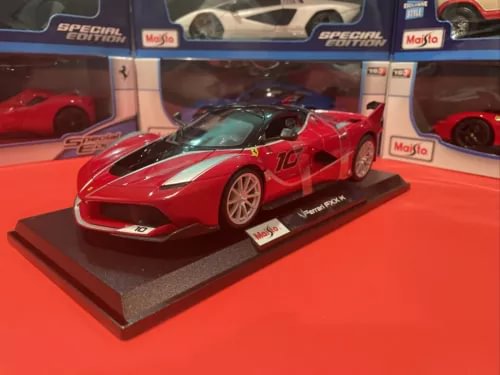 Red Ferrari FXX K 1/18 scale diecast sports car model with white racing stripe