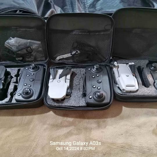 Camera drone kit in a black hard case with remotes and drone components