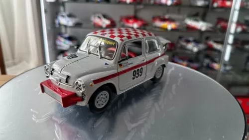 1:18 scale diecast rally car with gray body, red front bumper and side stripe, model 999