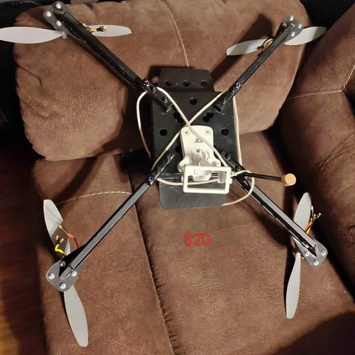 Four-rotor drone, black frame with four propellers and front camera mount.