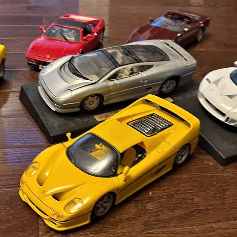 Yellow diecast model sports car with black stripe and hood vents