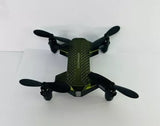 Compact folding micro drone with four propellers in dark green