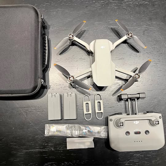 White DJI mini 2 drone with controller and battery accessories