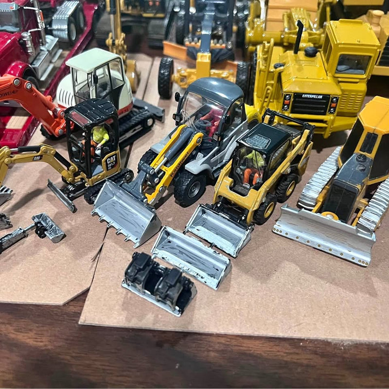 Set of 1/50 scale diecast construction vehicles, including yellow excavator and loader