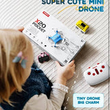 Mini drone starter set box with remote controller, held in hands