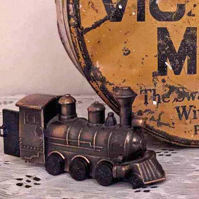 Metal train pencil sharpener with weathered finish and smokestack cab