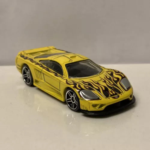 Yellow flame graphic diecast model car with black hood, front 3/4 view