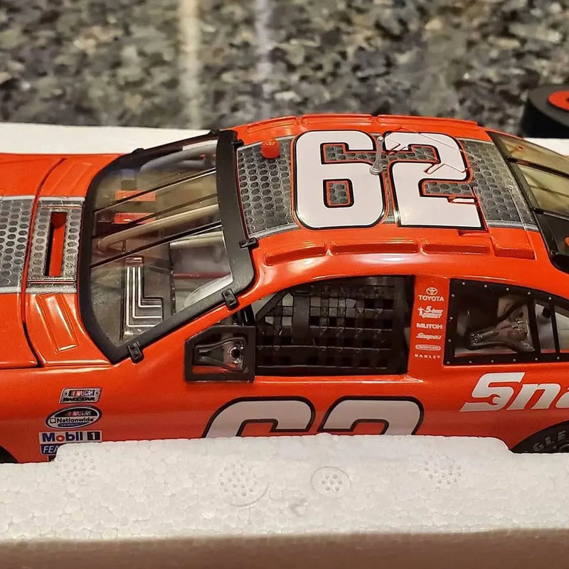 Orange diecast race car with open hood and detailed cockpit interior