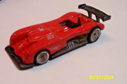 Red diecast race car roadster with black rear wing, detailed wheels