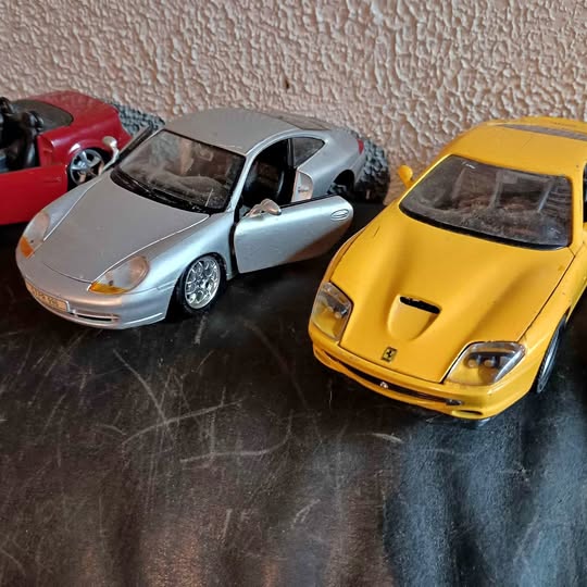 Diecast toy cars, yellow and silver classic sports cars
