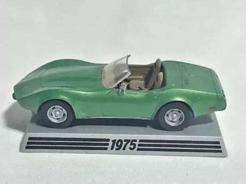 Green 1975 Corvette diecast model car with open cabin and chrome wheels