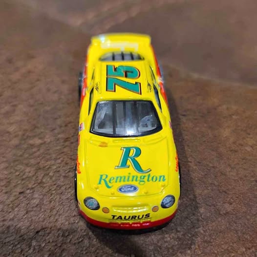 Yellow Nascar diecast race car with 12 and Remington logo on hood