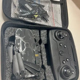 Gray remote controller with joysticks in molded case, keypad buttons and circular controls