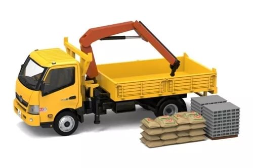 Yellow diecast crane lorry model with orange boom, dump bed, cargo sacks and crate