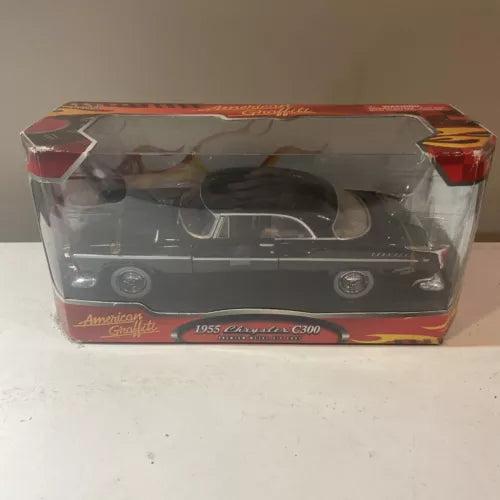 Black classic diecast car model in clear display box with red graphics
