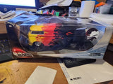 Hot Wheels diecast model car in display box, flame graphics, blue and yellow.