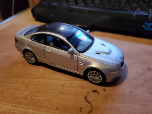 Silver die-cast sports car with black windows, front 3/4 view, pull-back style