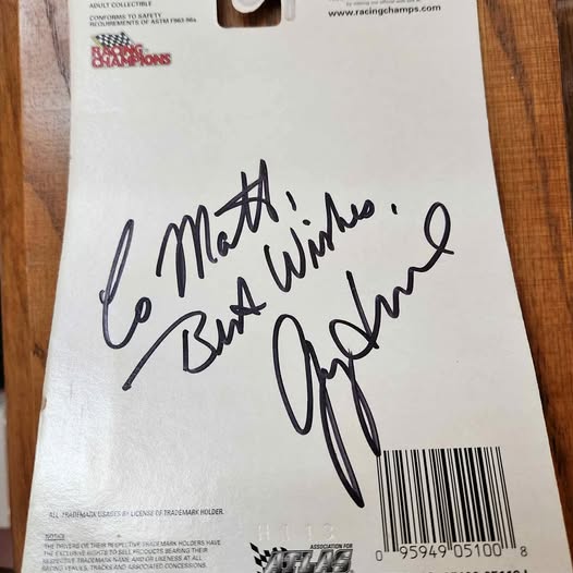 Collectible diecast racer card with handwritten signature and barcode