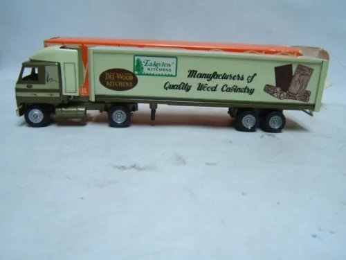 Green diecast tractor trailer with white box trailer and orange stripe, Mack cab
