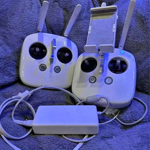 DJI drone remote controllers with antennas and charging cables, white