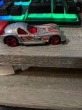 HOT WHEELS silver diecast sports car with orange fin accents