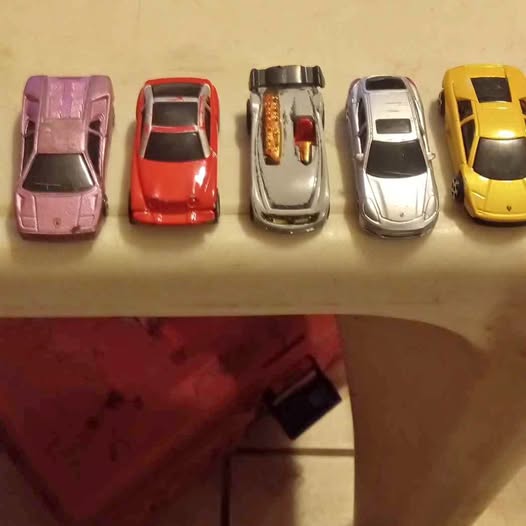 Maisto diecast car set of five assorted color cars on display: pink, red, silver, white, yellow