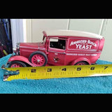 Red Budweiser diecast delivery truck with yellow measuring tape across front