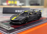 Matte black sports car diecast model with yellow racing stripes, front 3/4 view.