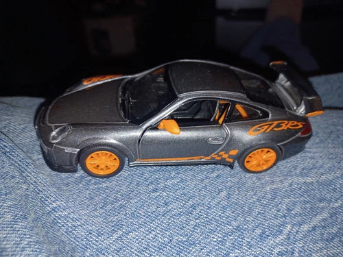 Diecast metal toy car, silver with orange wheels and racing decals, 1:36 scale