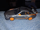 Diecast metal toy car, silver with orange wheels and racing decals, 1:36 scale