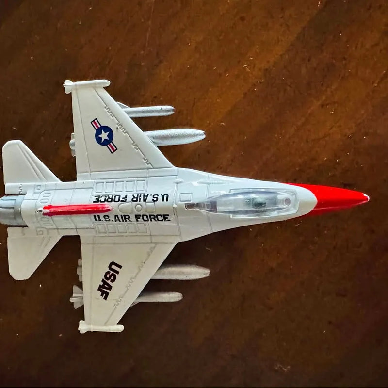White diecast bomber aircraft toy with red stripe and U.S. Air Force markings.