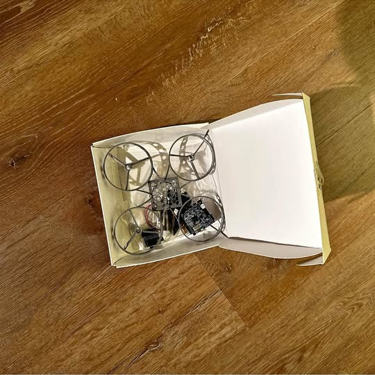 DIY drone kit in open box with drone frame and circuit board