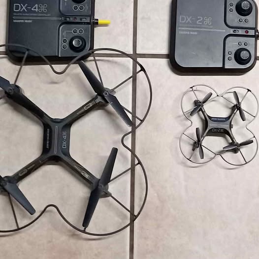 Folding quadcopter drone with four propellers and handheld controller