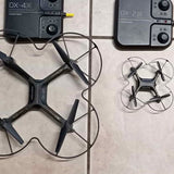Folding quadcopter drone with four propellers and handheld controller
