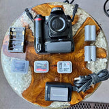 Nikon D80 DSLR camera kit with lens, memory cards, batteries, and cables
