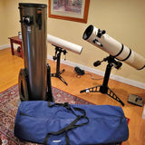 Telescope optical tube on tripod with blue carrying case and eyepiece accessories